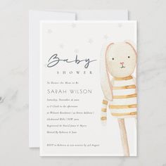 a baby shower card with a bunny in a pink and white striped shirt on it