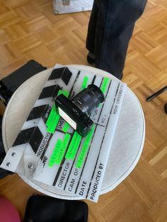 a camera sitting on top of a table in a room with hard wood flooring