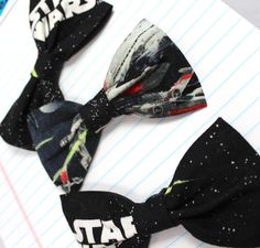 two bow ties with star wars on them sitting on top of a piece of paper