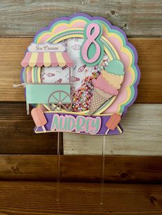 an ice cream birthday card with the number eight on it and cupcakes, sprinkles, and candies