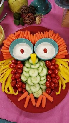 an owl made out of carrots, cucumbers and other fruits on a plate