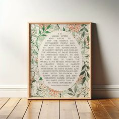 a wooden frame with a poem on it sitting on a floor next to a wall