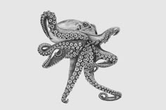 an octopus drawing in black and white on a gray background, with the tentacles curled up