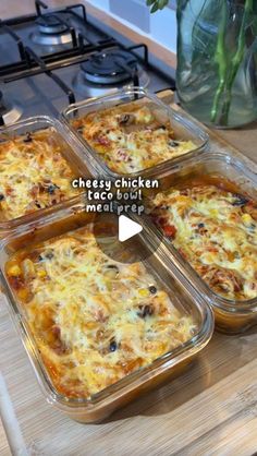 four casserole dishes sitting on top of a wooden cutting board