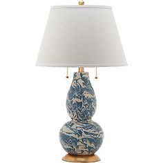 a blue and white lamp on a wooden base