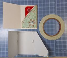 the inside of a box with tape, scissors and other crafting supplies next to it