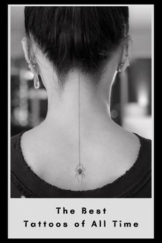 the back of a woman's neck with tattoos on it