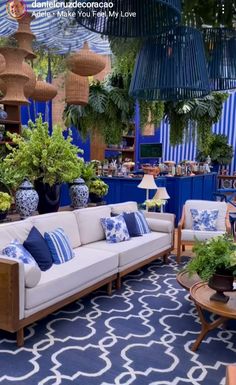 a living room filled with lots of furniture and plants in it's centerpieces