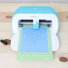 the cricut joy machine is sitting on a table next to a piece of paper