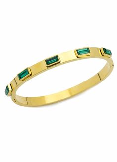 A gold metal bangle inlayed with emerald stones makes a perfect complement for your watch. Stand out with stylish bangles, wear them on their own or combine them together for a stack! Stainless steel hypoallergenic jewelry that is non reactive for sensitive skin and won't rust or tarnish. Artizan Jewelry is water resistant but it is recommended to use a jewelry cleaning cloth to help preserve color and shine. Stainless steel 18k gold plated 5 emerald zirconia stones encrusted 2.8" x 1.77" - Suit Adjustable Gold Bangle With Jewels, Gold Stackable Emerald Jewelry, Green Gold-plated Bangle, Gold Bangle With Emerald As Gift, Stackable Gold Bangle Bracelet, Gold Emerald Bangle As A Gift, Green Metal Bangle Jewelry, Modern Green Bangle Jewelry, Elegant Gold Bangle With Emerald