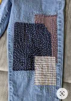 a patchwork denim jacket with different colors and patterns