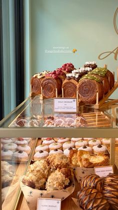 a display case filled with lots of different types of doughnuts and pastries