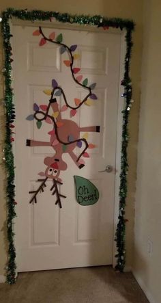 the door is decorated with christmas lights and garlands for an animal themed front door