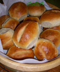 bread rolls in a basket on a table