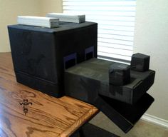 a wooden table topped with two black boxes