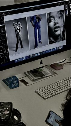 a person sitting at a desk in front of a computer monitor with pictures on it