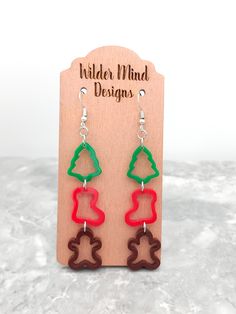 Christmas Cookie Cutter Earrings! These are hand painted, laser cut, laser engraved earrings made with green, red and brown acrylic. They are super lightweight making them easy to wear all day!  *Please Reference Size Guide Picture for sizing* Ear wires are made from surgical stainless steel. Since these earrings are handmade, I highly recommend taking them off for any water related activities such as swimming or showering and while sleeping. They come packaged on an earring card holder in an or Glowforge Acrylic Earrings, Handmade Christmas Earrings, Laser Cut Earrings Wood, Christmas Earings, Earring Card Holder, Xtool F1, Christmas Tree Gingerbread