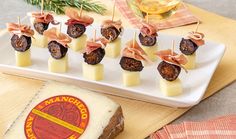 small appetizers are arranged on a platter with cheese and meats in the middle