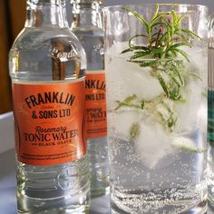 three bottles and two glasses filled with tonic water, one containing frankland gin and the other containing tonic water