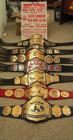 a group of belts sitting on top of a carpeted floor