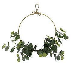 a circular wreath with green leaves hanging from it