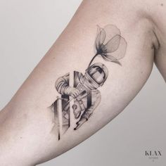 a woman's arm with a tattoo on it that has a bow and flower