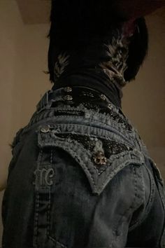 the back of a person's jean jacket with studs on it