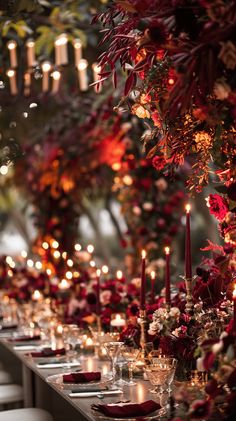 a long table with candles and flowers on it is set up for a formal dinner