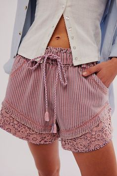 A true only-at-FP pair, these statement shorts from our We The Free collection will turn heads from this season to the next. **Fit:** Mid-rise, slouchy relaxed fit **Features:** Pull-on design, drawstring detail with tassels, crochet embroidered trimming, oversized pockets **Why We ❤ It:** Timeless with tall boots or off duty with sporty sneakers, this pair has endless ways to wear. | We The Free Shake It Railroad Shorts at Free People in Pink, Size: S Tassels Crochet, Diy Ripped Jeans, Social Graces, Statement Shorts, Cozy Weekend, Oversized Pockets, Work Fits, Drawstring Detail, Peachy Keen