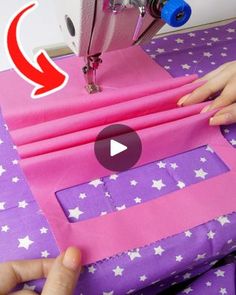 someone is using a sewing machine to sew stars on pink paper with purple background