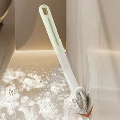 an electric toothbrush sitting on top of a bath tub filled with bubbles