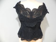 Gorgeous vintage black alencon lace blouse for evening wear. It is labeled Watters and Watters with the fabric contents and care pictured. My guess is 60's - 80's . This lace is fabulous with heavy cording around the flowers in an all over floral pattern. The top has slight off the shoulder wide straps or sleeves which fall to a v shape on both front and back. It is fitted along the waist. All edges have the eyelash of the lace showing on the scalloped edging. Inside is lined in both a netting a Evening Blouses, Alencon Lace, Peep Toe Shoes, Needle Lace, Wide Straps, Lace Blouse, V Shape, Evening Wear, Vintage Black