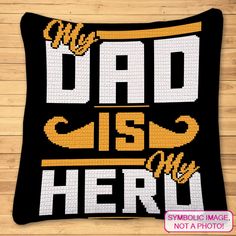 a black and yellow pillow with the words dad is hero on it