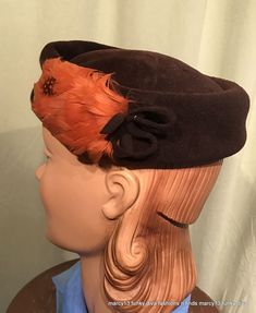 "This is a cute vintage pillbox style hat, that dates from the 1950s or early 60s. Label reads, \"Genuine Velour\". Made of dark brown velour with orange feather on each side, accented by small velour bows. Measures 21\" inside, but is really just a one size hat, as it was made to perch on your head. The hat is in good vintage condition. No wear or soil. Sweet!" Vintage Cloche Fascinator For Formal Occasions, Vintage Hat-style Fascinator For Vintage Events, Vintage Hat Fascinator For Vintage Events, Retro Adjustable Felt Hat For Formal Occasions, Vintage Costume Hats And Headpieces For Party, Adjustable Retro Felt Hat For Formal Occasions, Retro Costume Hats And Headpieces For Church, Retro Mini Hats For Kentucky Derby And Vintage Events, Retro Fascinator Hat For Formal Occasions