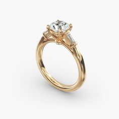 a yellow gold engagement ring with three stones