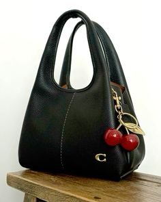 coach bag, cherry accessories Coach Bag With Cherry Charm, Cherry Coach Bag, Coach Cherry Bag, Cute Bags And Purses, Cherry Accessories, Purses Aesthetic, Coach Aesthetic, Aesthetic Purse, Cherry Bag