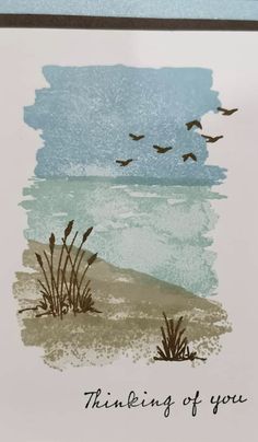 a card with birds flying over the water and sand on the beach that says, thinking of you