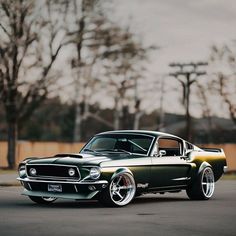 an old muscle car is parked on the street