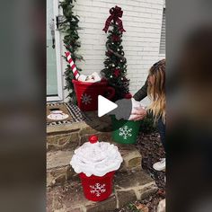 the woman is decorating her christmas cupcakes outside