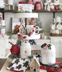 a christmas tree made out of coffee mugs on top of a wooden table with other items