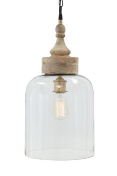 a clear glass and wood pendant light with an old fashioned bulb hanging from the ceiling