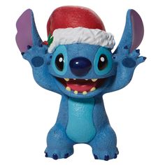 a blue toy with a red hat on it's head and arms, smiling