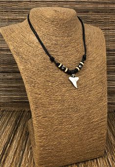 "Shark teeth necklace Adjustable Shark Tooth Unisex Necklace Handmade Necklace. Adjustable cord with sliding knots from 15\" Inches up to 30 Inches Around the Neck. Adjustable Cord - Fits Most Size. Use this necklace short or long. Pull the knots to adjust the length. This beautiful necklace is simply stunning. Our commitment to excellent quality ensures each piece is skillfully inspected.Order this today or browse our incredible selection of jewelry. FAST SHIPPING! To visit my Etsy Shop: https: Adjustable Casual Pendant Necklace, Casual Adjustable Pendant Necklace, Casual Black Pendant Jewelry, Black Jewelry With Adjustable Chain For Beach, Black Casual Necklace With Adjustable Cord, Casual Black Necklace With Adjustable Cord, Shark Tooth Necklace Aesthetic, Sharks Tooth Jewelry, Beaded Shark Tooth Necklace