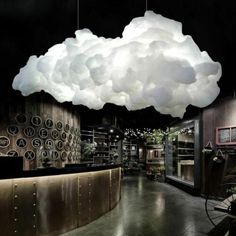 a large cloud hanging from the ceiling over a restaurant