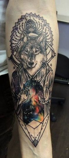 a tattoo on the leg of a person with an image of a wolf and space