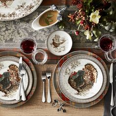 a place setting with turkey plates and silverware