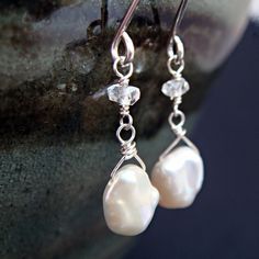 Lustrous white keishi pearls dangle below sparkling clear topaz rondelles in these lovely pearl earrings. These are great for everyday and still special enough to leave on when you go out at night! They're petite and perfect for those who want a touch of glint without too much length. Total earring length is approximately 1 1/8 inches (2.9 cm). Pearl size is around 6 mm x 5 mm, with a little natural variation. See more~ Pearl jewelry- http://www.etsy.com/shop/aubepine?section_id=6718985 Silver e Teardrop Pearl Crystal Earrings As Gift, White Crystal Earrings With Pearl Drop For Anniversary, Pearl White Rondelle Jewelry With Pearl Drop, White Crystal Pearl Drop Earrings As Gift, Sterling Silver Dangle Crystal Earrings With Pearl Drop, Sterling Silver Pearl Earrings With Gemstone For Wedding, Wedding Pearl Earrings With Gemstones In Sterling Silver, Delicate Crystal Earrings With Pearl Drop For Gift, Sterling Silver Crystal Earrings With Pearl Drop For Gift