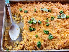 a casserole dish with cheese and spinach