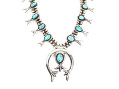 Vintage turquoise squash blossom necklace has an exciting large sterling silver removable naja in a Southwest Navajo style. Blossoms and naja are sand cast sterling silver with graceful forms. Handmade bench beads strung on chain form the feature double strand, and graduate to smaller beads at the ends. Naja has a broad hook on the back and can be removed and worn by itself on a chain or leather strap offering several different looks. There are two slightly smaller beads where the naja attaches, indicating its proper placement. Unisex in style and heavy in weight. Hand shaped natural turquoise displays inclusions, including some hairlines and tiny voids (nothing distracting). Wonderful variable patina (I have polished with a soft untreated cloth). Chain has a little extra length for proper Squash Blossom Necklace Sterling Silver Mounted, Vintage Squash Blossom Necklace, Southwestern Style Adjustable Hand-strung Turquoise Necklace, Turquoise Squash Blossom, Adjustable Southwestern Hand-strung Turquoise Necklace, Navajo Style, Southwestern One-of-a-kind Turquoise Necklace, Squash Blossom, Sand Casting