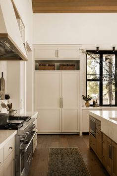 a kitchen with an oven, stove and sink in it's center island area